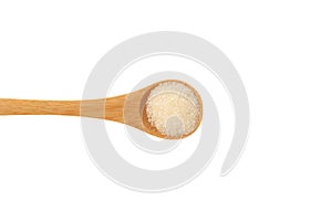 Gelatin granulated or gelatine powder in wooden spoon isolated on white background, close-up. Food additive E441, Hydrolyzed