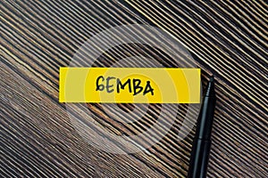 Gemba write on sticky notes isolated on Wooden Table photo