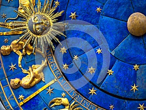 Gemini astrological sign on ancient clock. Detail of Zodiac wheel with Sun and Twins photo