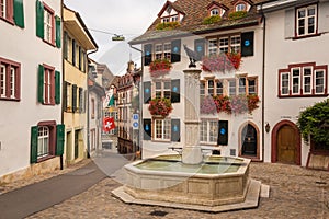 Gemsberg fountain and colorful buildings in Basel