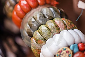 Gemstone bracelets and necklaces in a row. Jewelry made of red jasper, unakite stones, obsidian stones and white onyx stone.