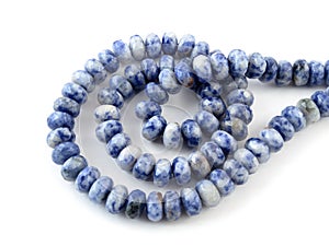 Gemstone natural lapis lazuli on white background, beads