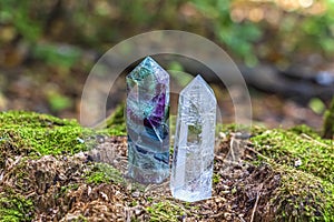Gemstones fluorite, quartz crystal. Magic rock for mystic ritual, witchcraft Wiccan and spiritual practice on stump in forest.
