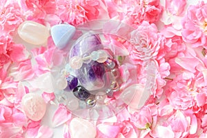 Gemstones in pink rose petals and flowers