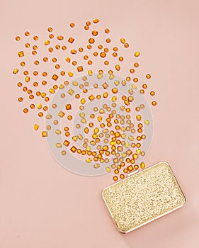 Gemstones spilling out of a golden purse