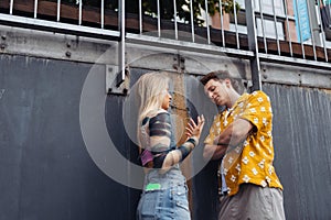 Gen Z couple having an argument outdoors in the city.