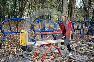 Gen z, generation z, Zoomers device addiction, digital detox. Teenager girl alone rides on a swing in an autumn park