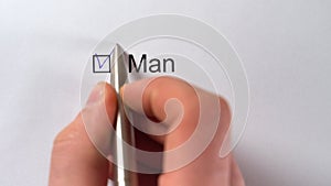 Gender choice Man or Woman. Hand draw a tick in the Man checkbox on white paper with pen. Diversity Checkbox Marking