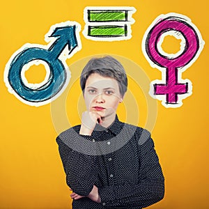 Gender equality concept with male and female symbol over yellow wall. Sex sign social issue metaphor