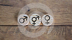 Gender equality conceptual image. Male and female symbol on wooden circles on beautiful wooden background. Copy space