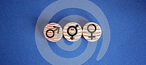 Gender equality conceptual image. Male and female symbol on wooden circles on beautiful blue background. Copy space