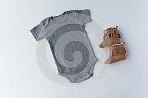 Gender Neutral Grey Baby Bodysuit & Shoes - Unisex Baby Clothing Mockup photo