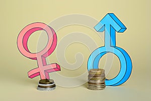 Gender pay gap. Male and female symbols near piles of coins on beige background