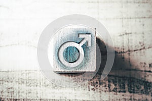 Gender Sign For Male On A Blue Wooden Block On A Table