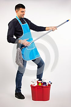 Gender stereotypes and good mood. A man at home dancing with a mop on a white background