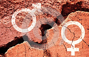 Gender symbols on earth background with a big crack