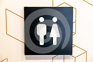 Gender Symbols on Restroom Sign with Hexagon Pattern