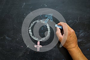 Gender symbols or signs for the male and female sex drawn on a blackboard