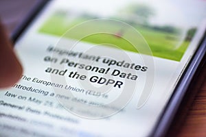 General Data Protection Regulation - closeup human finger pointing to smartphone screen message with text GDPR