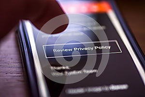 General Data Protection Regulation - GDPR - closeup human finger pointing to smartphone message with button Review