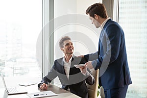 Boss giving money premium to happy employee