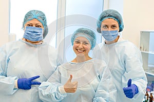 General photo of surgeons and a smiling patient after a successful operation