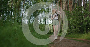 General plan mobile phone in the hands of a female traveler walking through the forest. Social networks Navigator and