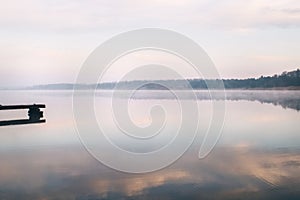 General plan of the pier for fishermen, which is located on a misty lake. The mist on the water creates the feeling of a magical