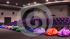 General plan of pink red empty unoccupied seats in the cinema hall. Watching a new movie panoramic photo