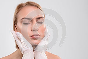 General practitioner analyzing human facial skin