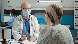 General practitioner attending consultation with senior patient