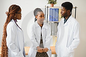 General practitioner and doctor and nurse as african american medical team at hospital.
