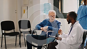 General practitioner doing consultation with old person in wheelchair