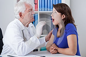 General practitioner examining throat