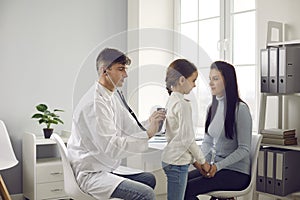 General practitioner, family doctor or pediatrician listening to little patient's lungs