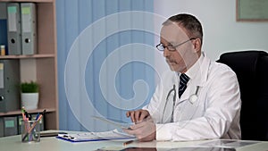 General practitioner keeping electronic medical records, contemporary medicine