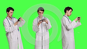 General practitioner playing video games on mobile phone app