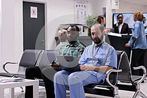 General practitioner reviewing patient situation on computer at hospital