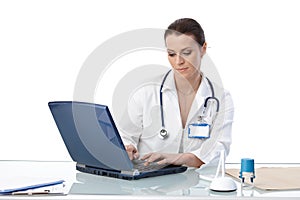 General practitioner typing on computer