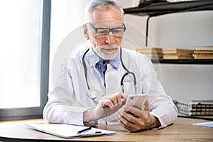 General practitioner using smartphone for making appointment and checking schedule