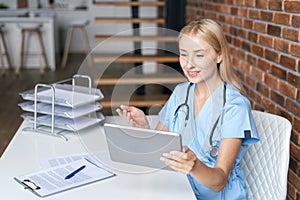General practitioner using tablet, make video call