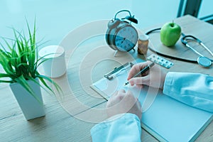 General practitioner writing notes during medical exam