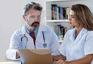 General practitioner with young female doctor