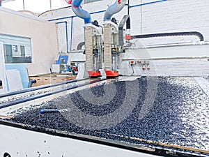 General view of a factory CNC machine cutting through Polyethylene