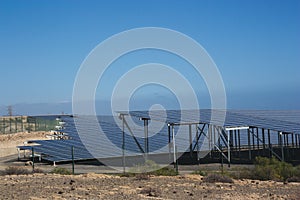 General view from the side of an electric power plant with solar panels.