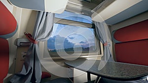 General view of a train`s cabin in the twilight. Travelling by train concept. Railroad trip concept.