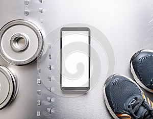 A smartphone with white screen and sneekers on metal background