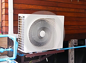 Big air conditioner compressor source heat pumps on brown wood wall