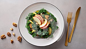 Kale apple walnut salad on a white dinner plate
