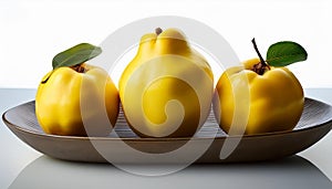 Arrangement of three fresh yellow quinces
